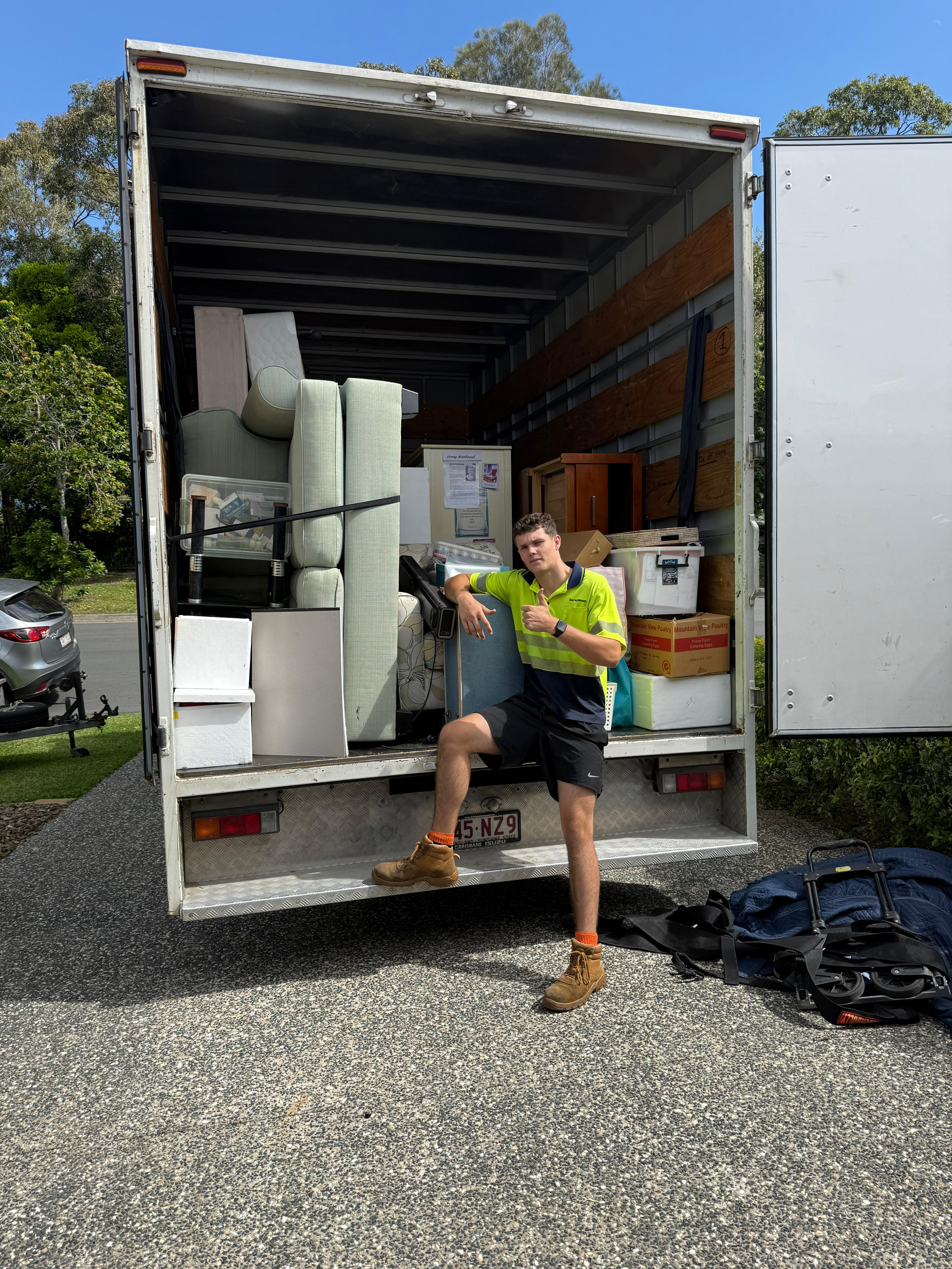 Pickup Pals driver with fully loaded truck, thumbs up